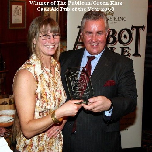 Judi is presented with her award by Greene King Brewing Company sales director Greg Williams